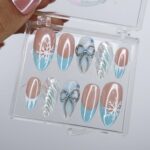 Winter Press On Nails with Snowflake & Silver Bow Design | Fake Nails in Medium Almond | Handmade Nail Art for Christmas Or Holiday Season