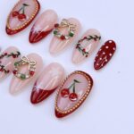 Christmas Press On Nails with Cherries, Snowflakes & Wreath Charms | Fake Nails in Medium Almond | Handmade Holiday Nail Art Gift Set - Image 3