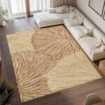 A washable area rug with a warm beige and caramel-toned leaf pattern. A textured botanical carpet perfect for decorating your living room or bedroom.