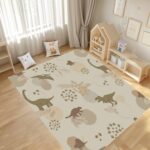 A soft, neutral-colored dinosaur area rug. A cute prehistoric animal pattern carpet, perfect for decorating nursery playrooms or toddler bedrooms. - Image 4