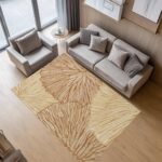 A washable area rug with a warm beige and caramel-toned leaf pattern. A textured botanical carpet perfect for decorating your living room or bedroom. - Image 3