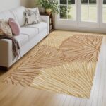 A washable area rug with a warm beige and caramel-toned leaf pattern. A textured botanical carpet perfect for decorating your living room or bedroom. - Image 2