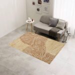 A washable area rug with a warm beige and caramel-toned leaf pattern. A textured botanical carpet perfect for decorating your living room or bedroom. - Image 5