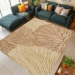 A washable area rug with a warm beige and caramel-toned leaf pattern. A textured botanical carpet perfect for decorating your living room or bedroom. - Image 7