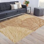 A washable area rug with a warm beige and caramel-toned leaf pattern. A textured botanical carpet perfect for decorating your living room or bedroom. - Image 6